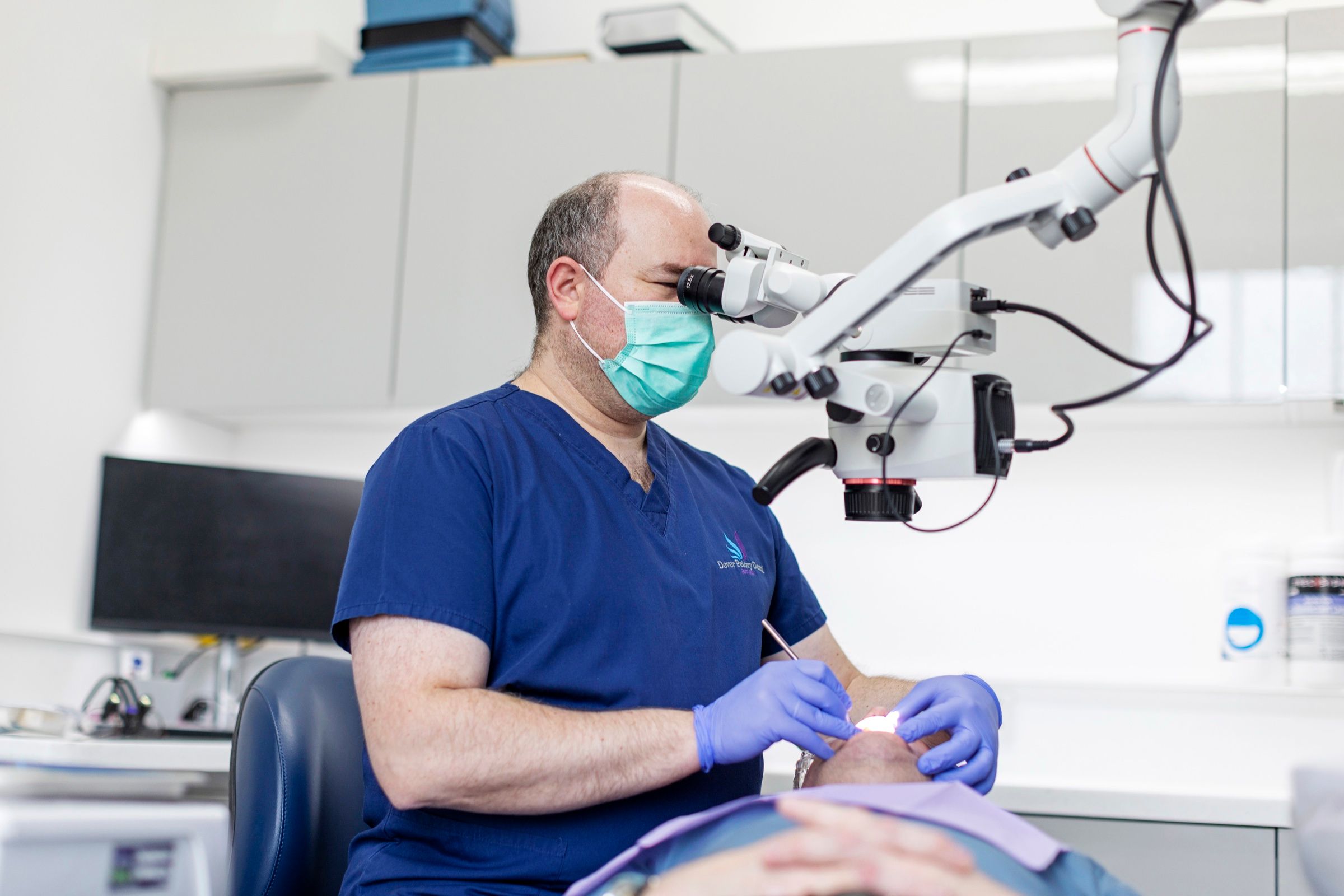 Dr Theo Mechteridis using a dental microscope in one of the surgeries